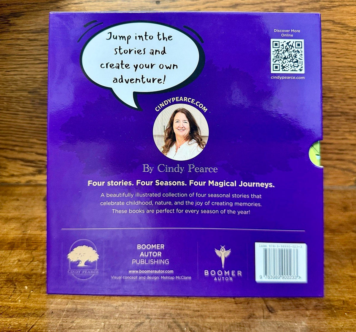 Back cover of stories for all seasons slipcase and with QR code on a wooden surface