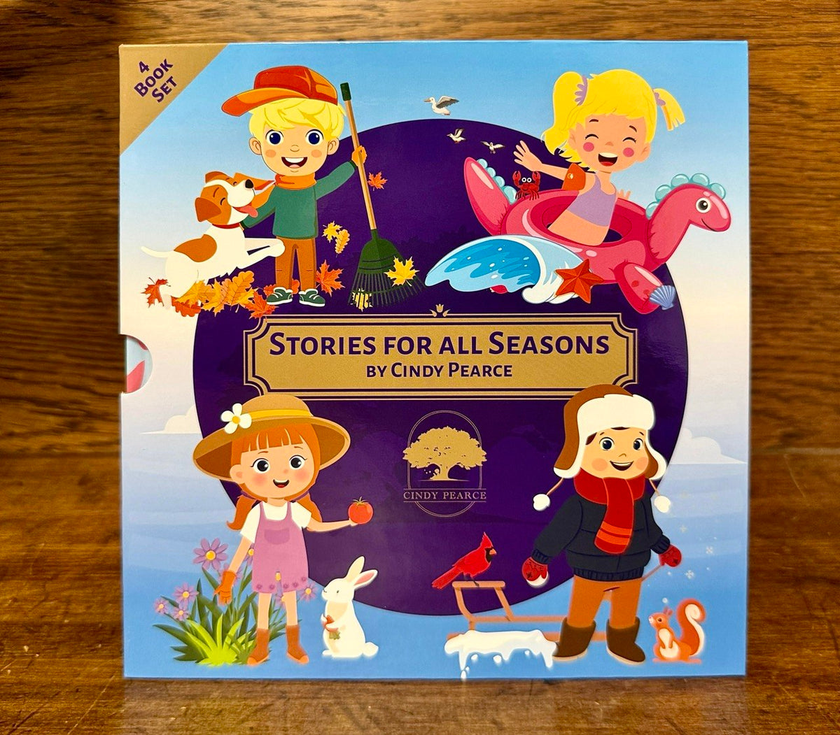 Slipcase with children's book set titled 'Stories for all Seasons' by Cindy Pearce on a wooden surface.